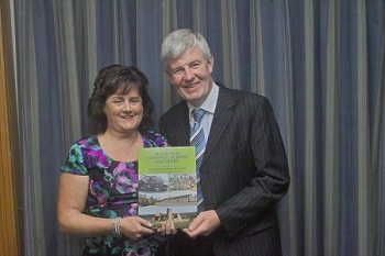 Paddy presenting Suzanne with a book 