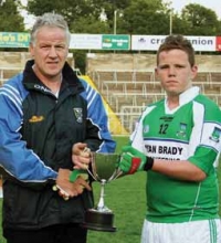Brian Seagrave presents the Cup to Under 13 winning captain Ciaran Keaney